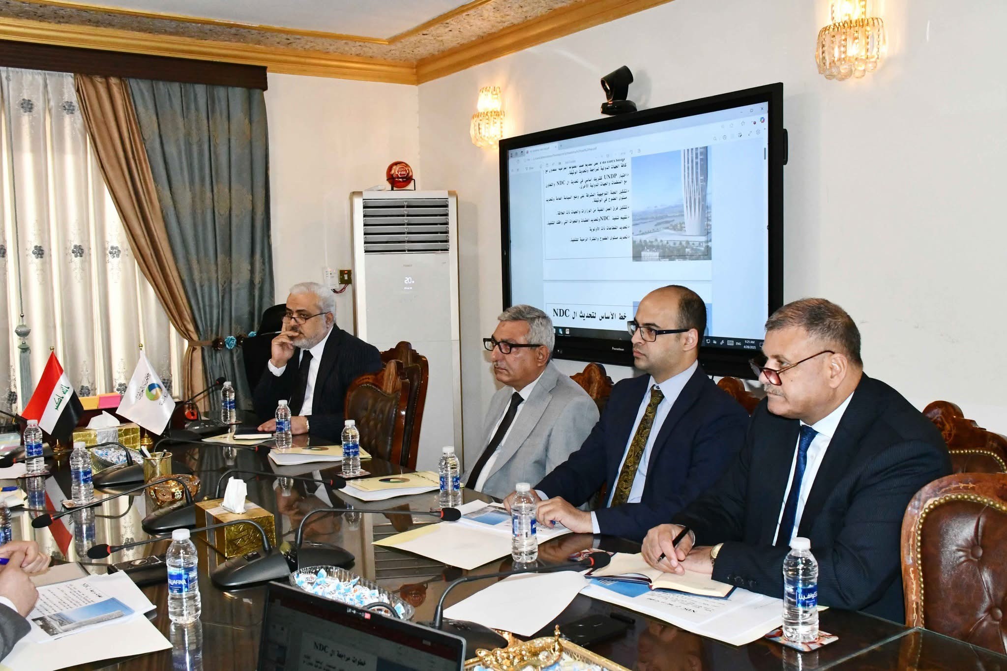 Iraqi NDC stakeholder meeting with mitigation material projected.